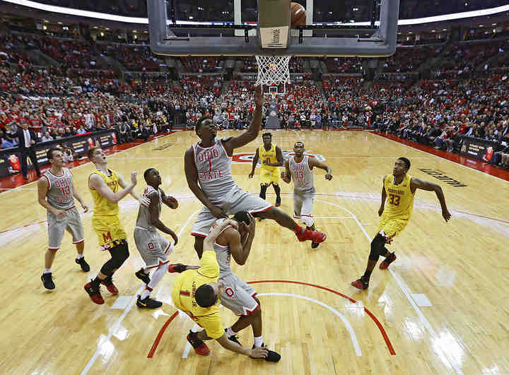 Ohio State forward Jae'Sean Tate (1) goes up to block a shot from Maryland guard Anthony Cowan (1) over teammate guard C.J. Jackson (3) during the first half of a game at Value City Arena in Columbus.  (Adam Cairns / The Columbus Dispatch)